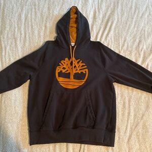 Timberland Men's Dark Hoodie with Bold Orange Emblem
